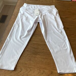 Kcutteyg white exercise capris with side pockets.  New with tags